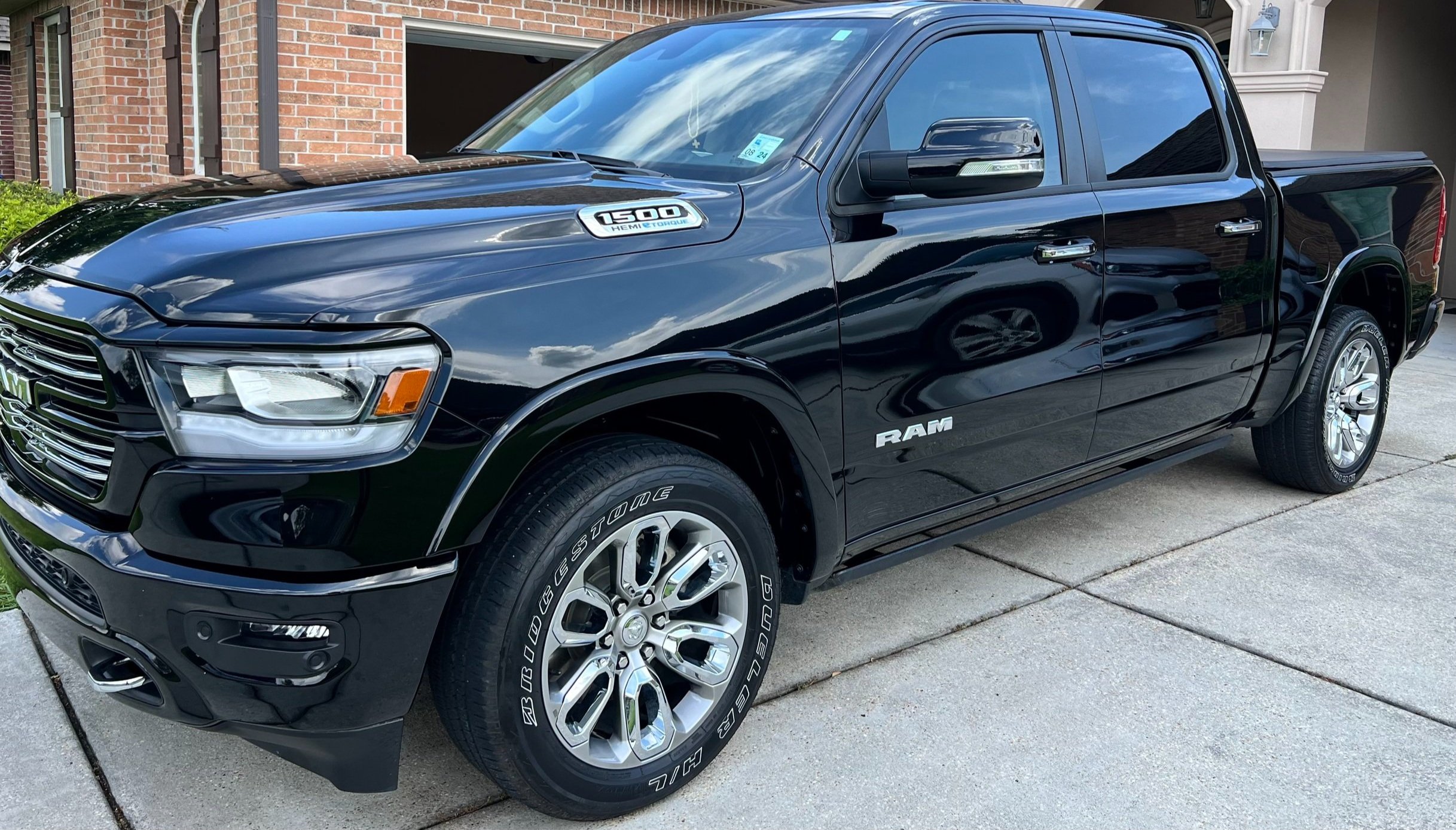 A black truck parked in front of a house